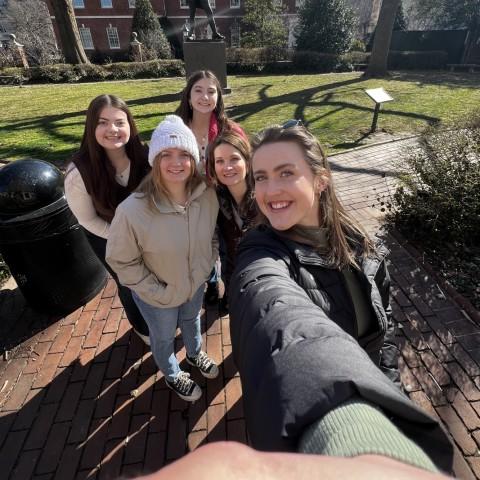 A group of UNE students and faculty take a selfie in front of Philadelphia's Independence Hall